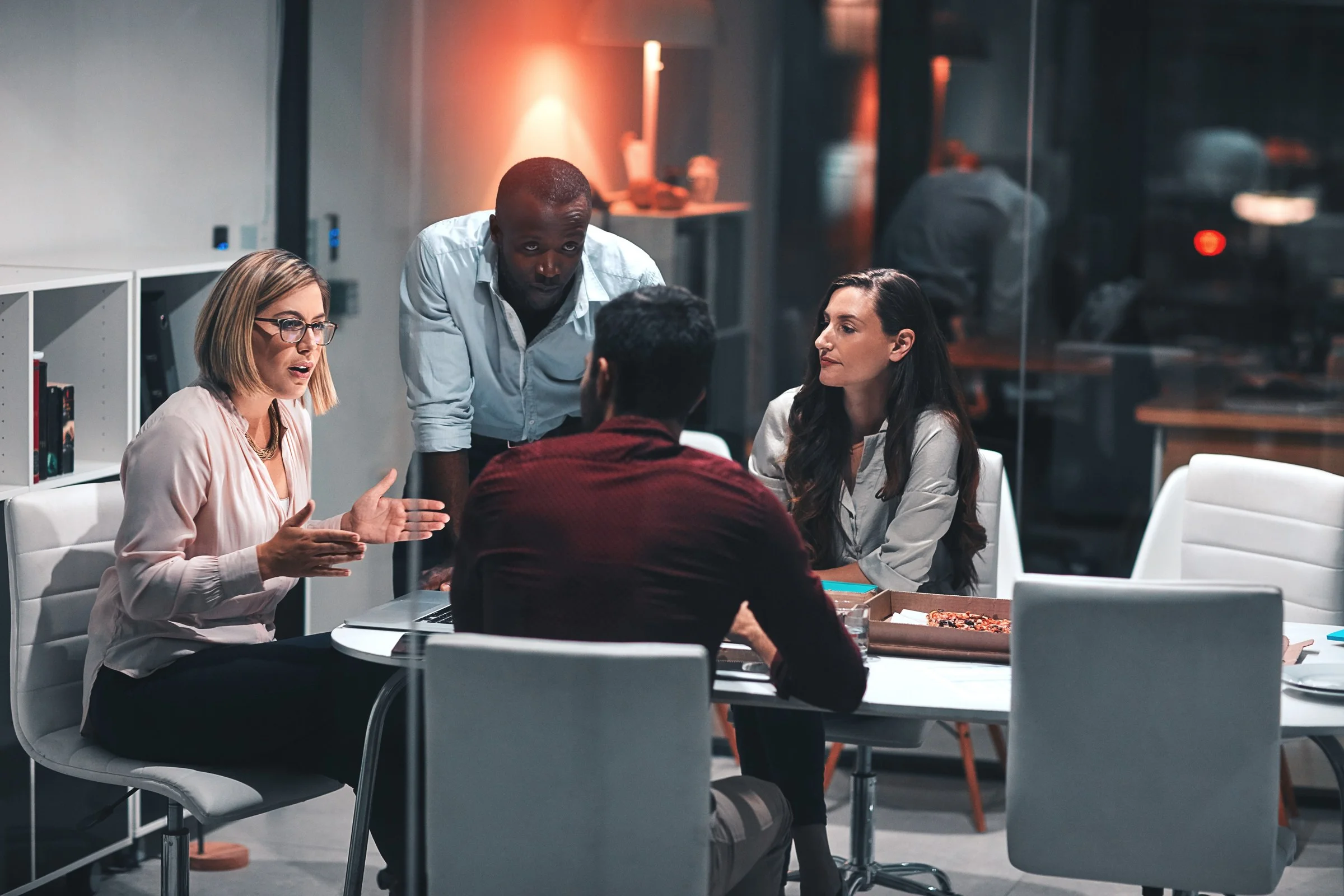 Colleagues talking around a meeting table